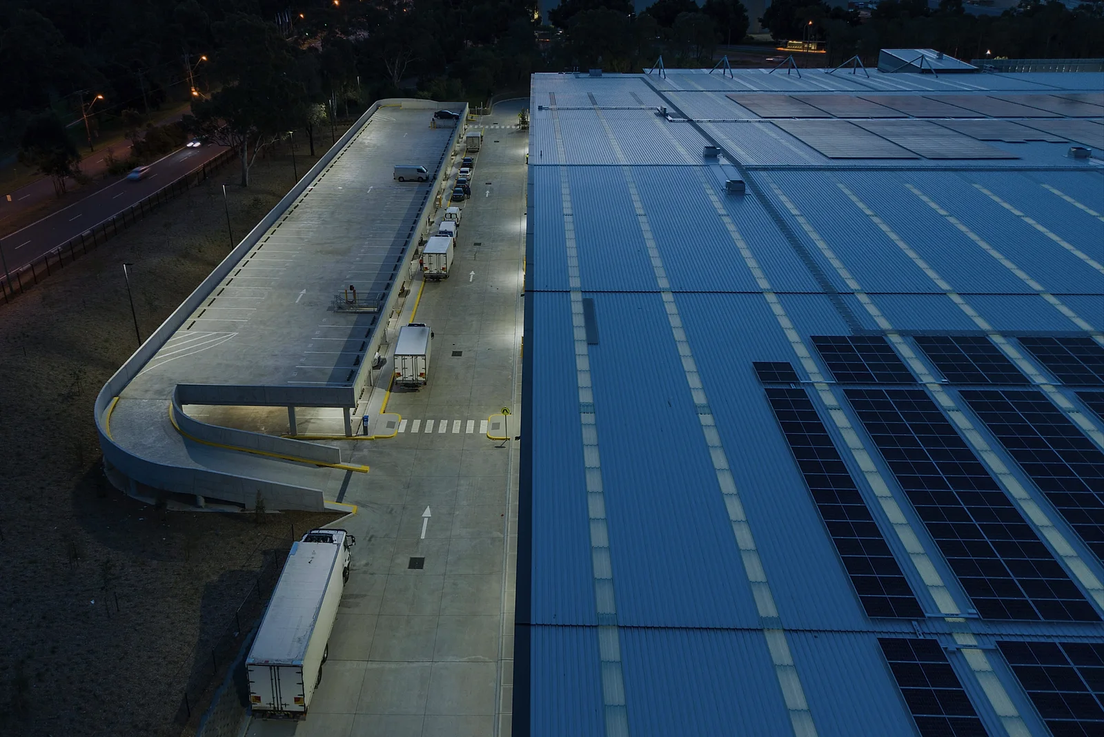 Commercial rooftop solar array at dusk