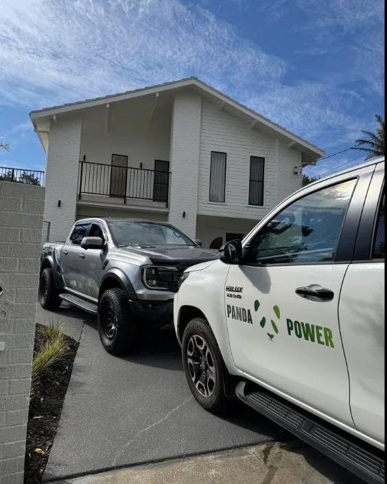 The Panda Power fleet out front of a modern home install