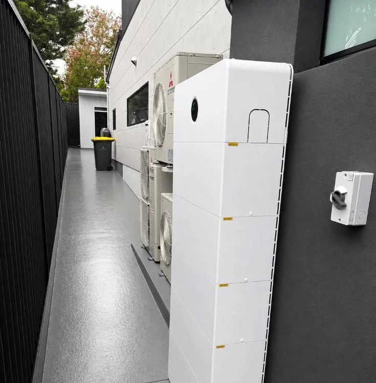 Battery system installed beside a modern home