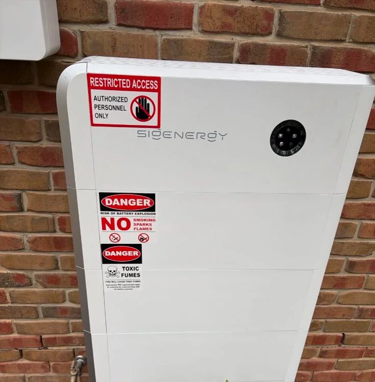 Sigenergy battery stack installed on a brick wall